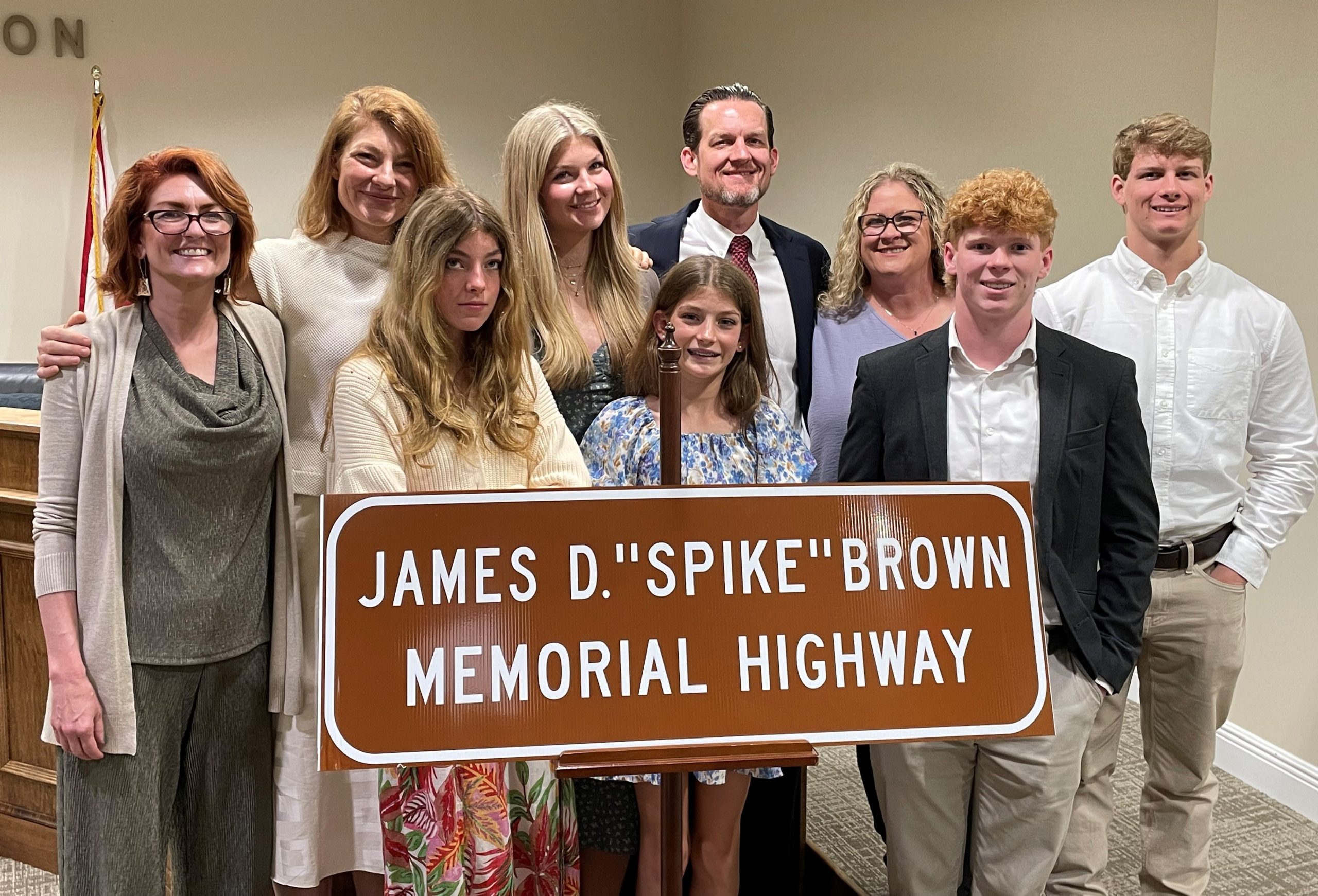Dr. Brown and family stand behind the James Brown Memorial Highway sign that was unveiled on I-22 Friday.
