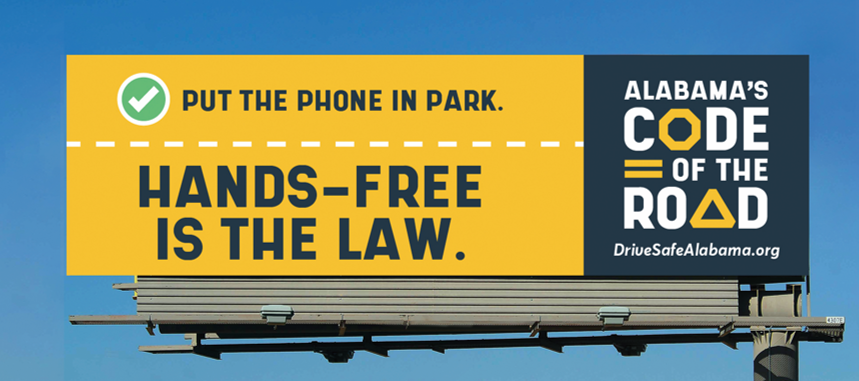 Hands-free law billboard saying "Put the phone in park. Hands-free is the law." and "Alabama's Code of the Road"