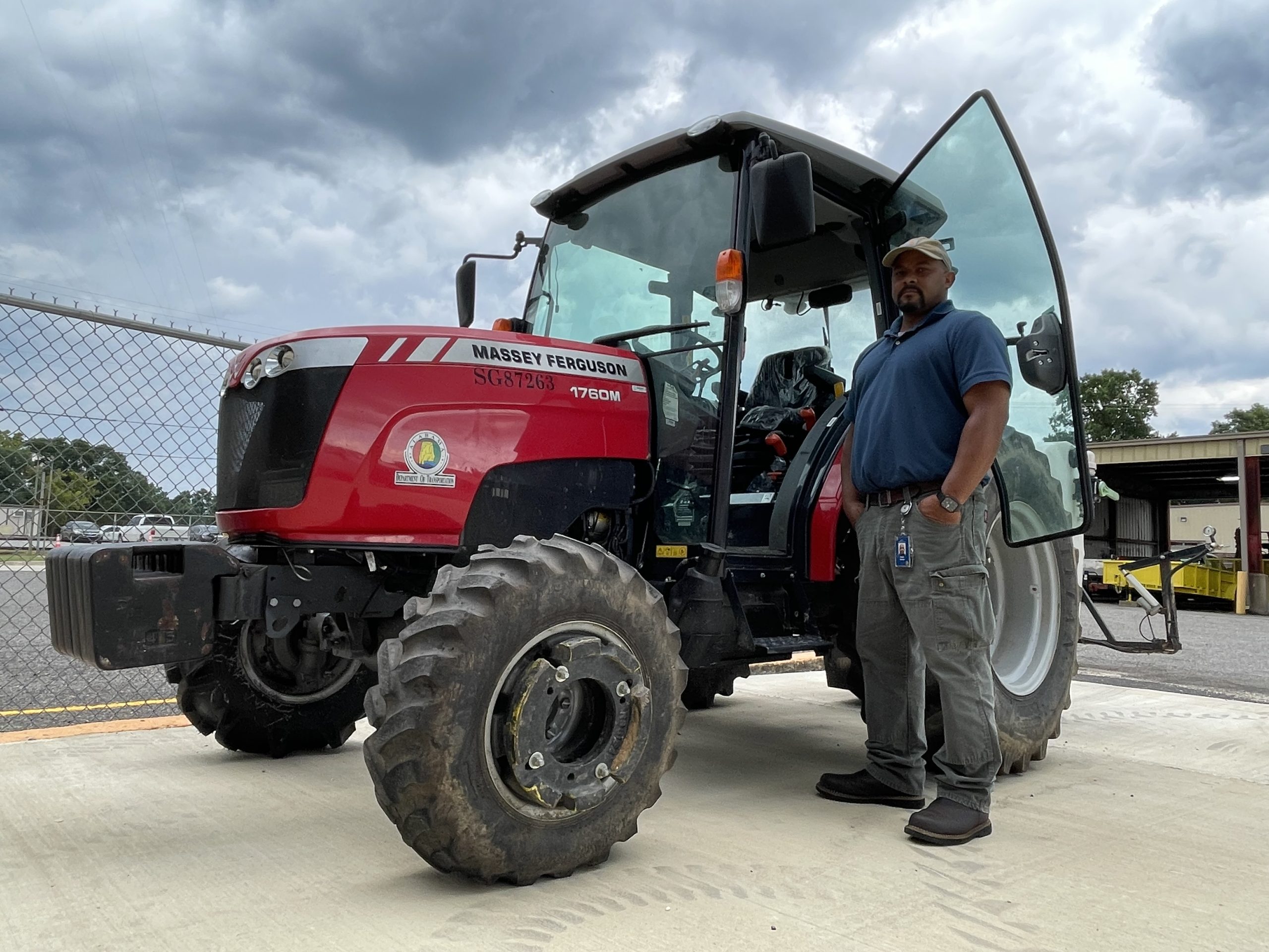 Steven Drake poses beside a tractor.