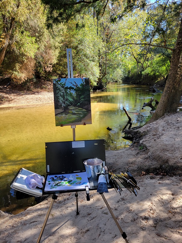 ALDOT employee Chris Blackwood's art palette and easel set up by a creek