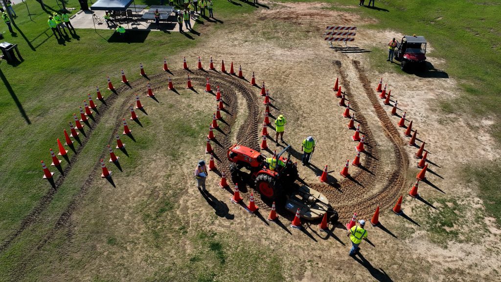 tractor being driven through a curved cone obstacle