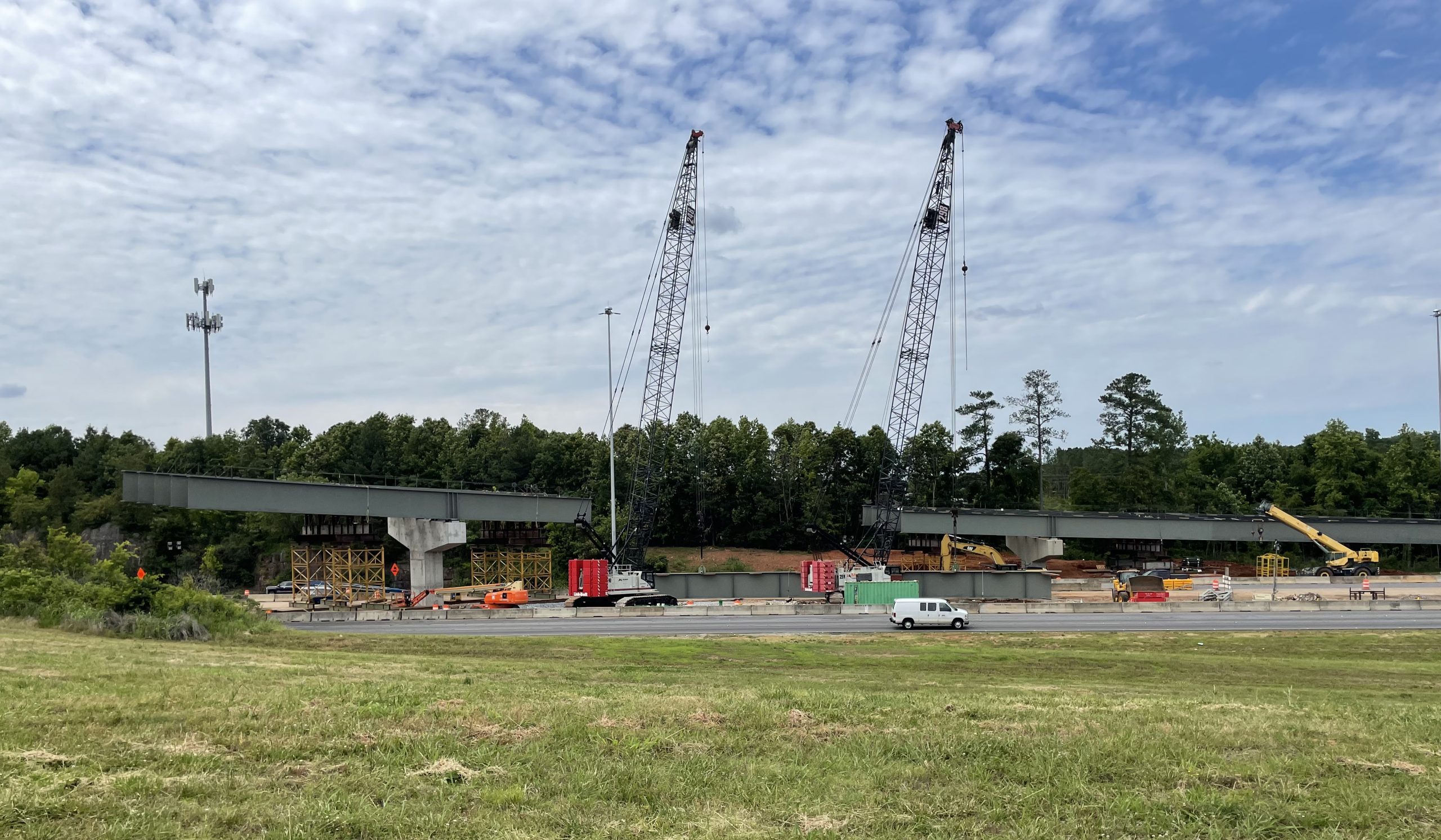 Cranes sit beside the I-565 Exit 10 westbound off-ramp, where some sets of girders have already been installed.