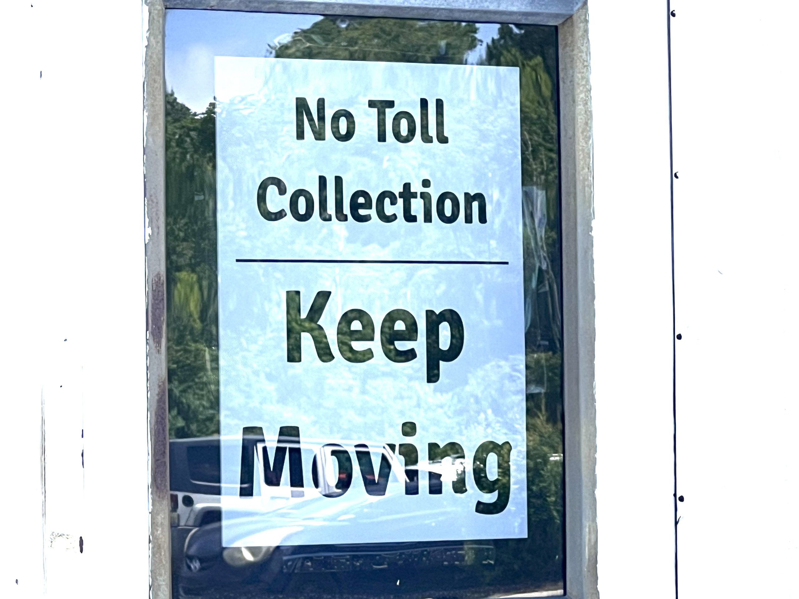 sign stating no toll collection, keep moving