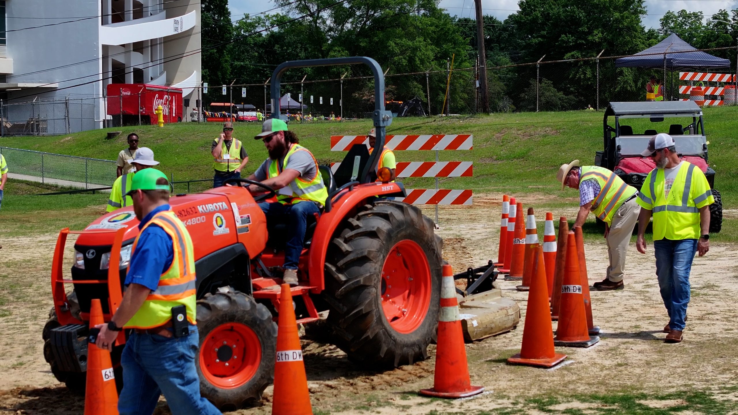 Man driving a tractor through an obstacle course made of cones