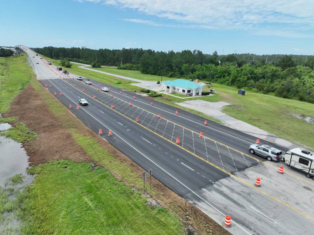 Road with no toll plaza and traffic flowing freely.