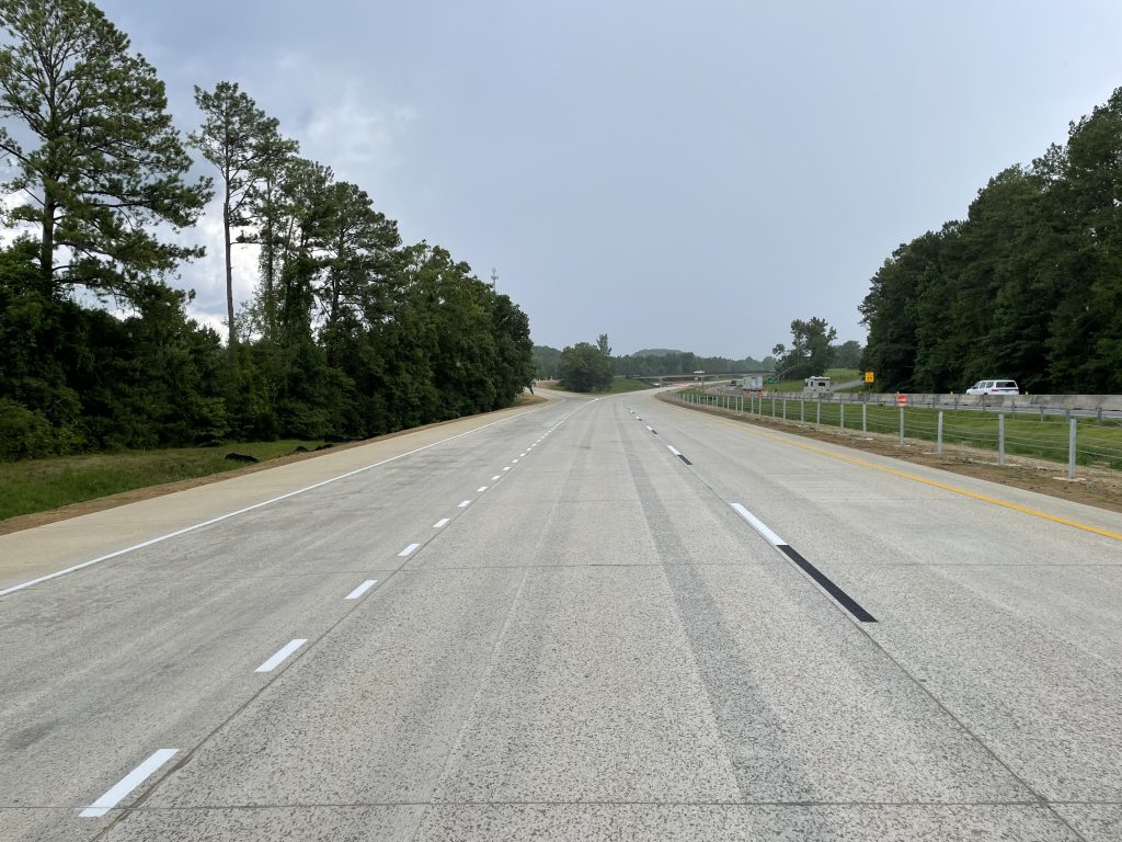 An on-ramp and acceleration lane merge into the reconstructed roadway.