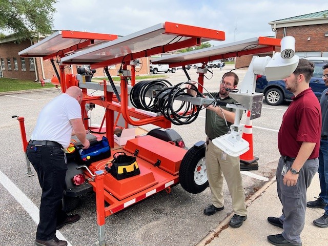 ALDOT engineers examine traffic detection equipment.