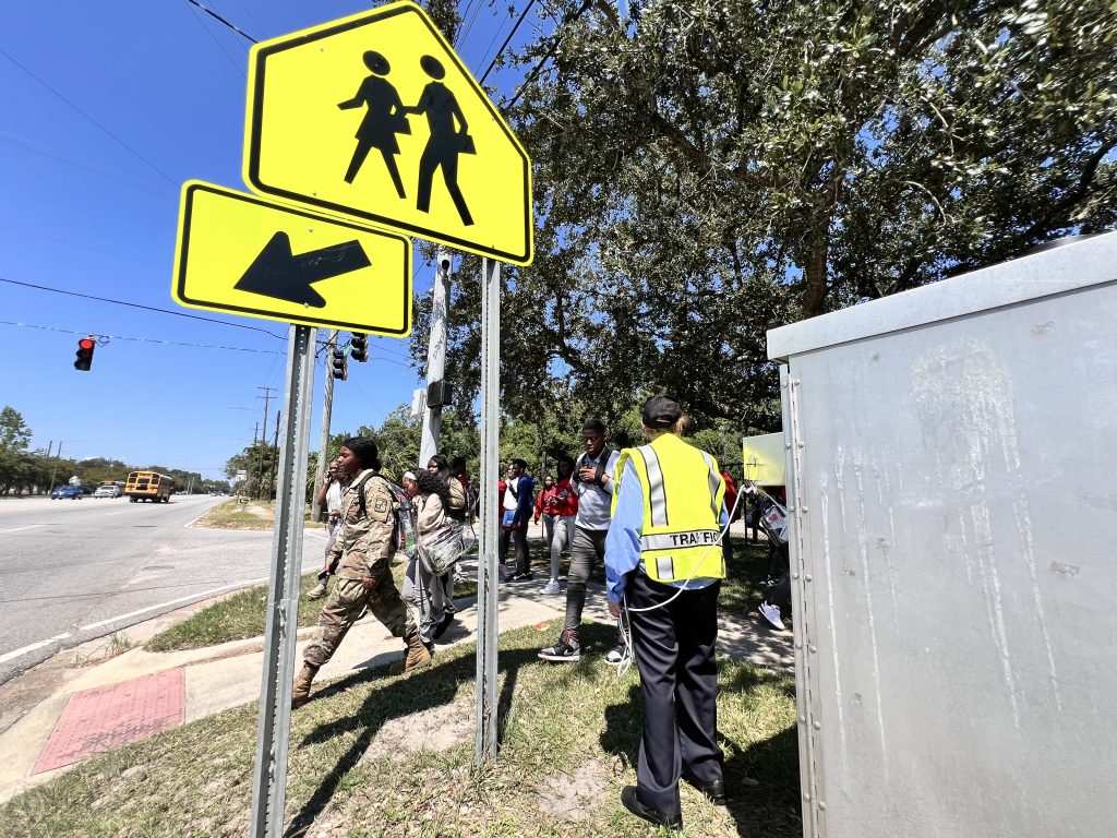 Community Resource Officers use the "pickle" to help students cross safely at intersections.