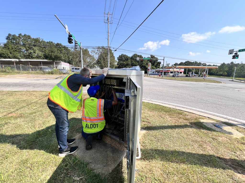 ALDOT workers working in a traffic signal cabinet