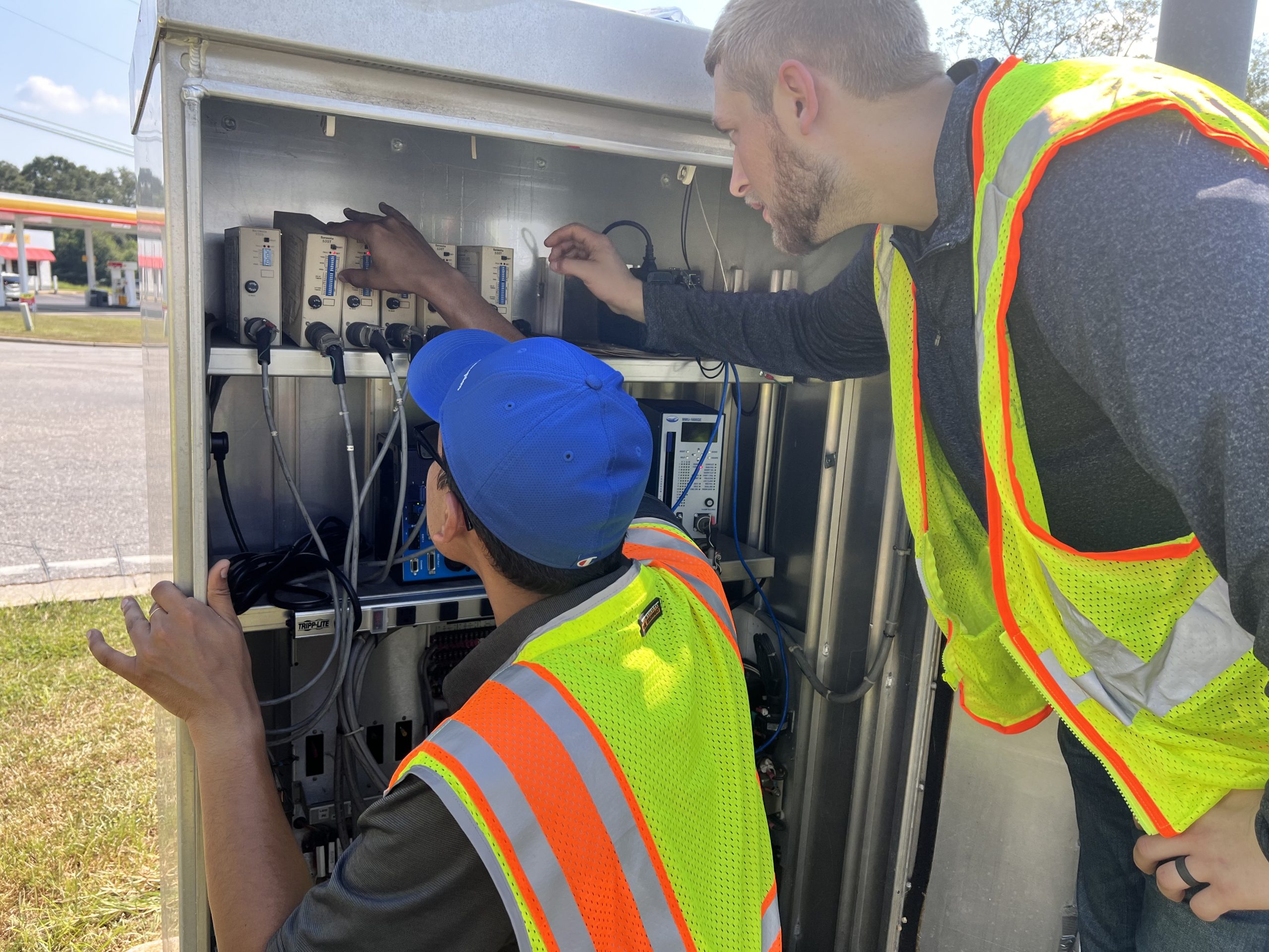 Traffic engineers inspect signal cabinet