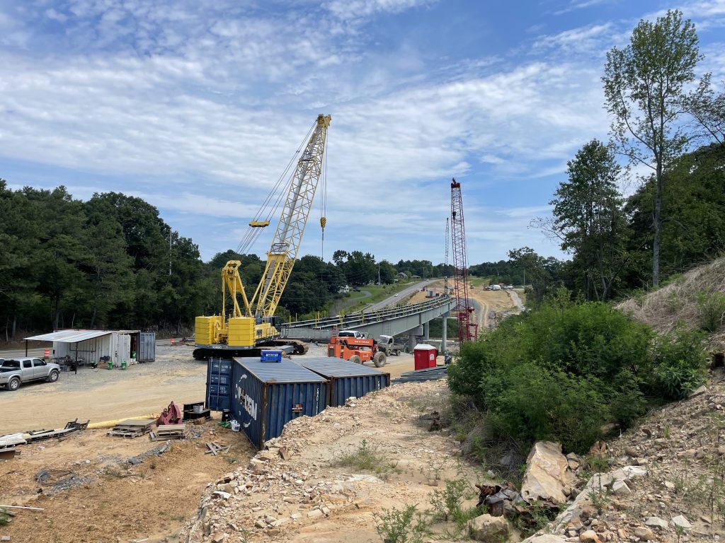 New bridge under construction with three cranes.