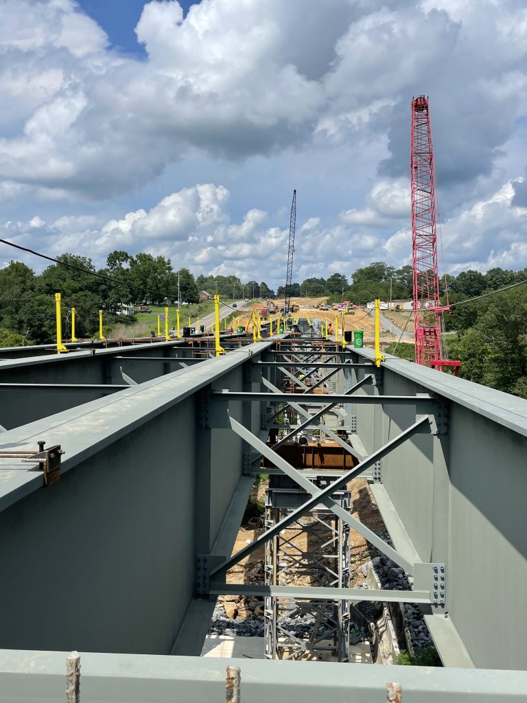 Smaller beams installed at intervals between the girders.