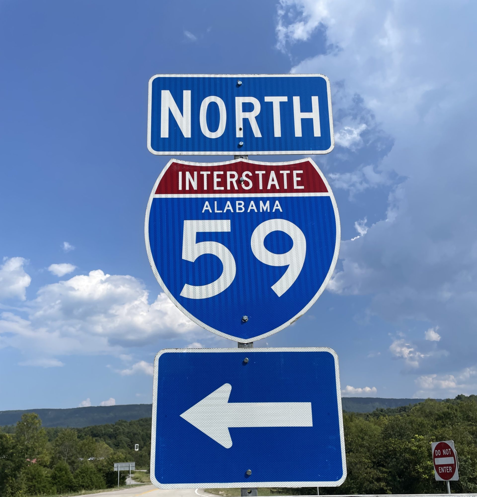 A sign for I-59 north with interstate shield and arrow pointing to on-ramp against a blue sky.