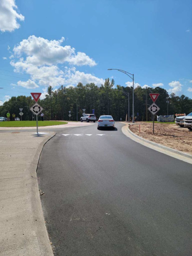 Cars in roundabout at N. College St and Farmville Rd in Auburn