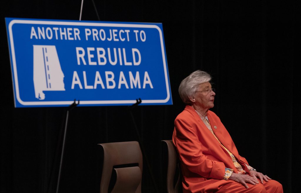 Governor Kay Ivey sits at a Rebuild Alabama event in Chilton County.