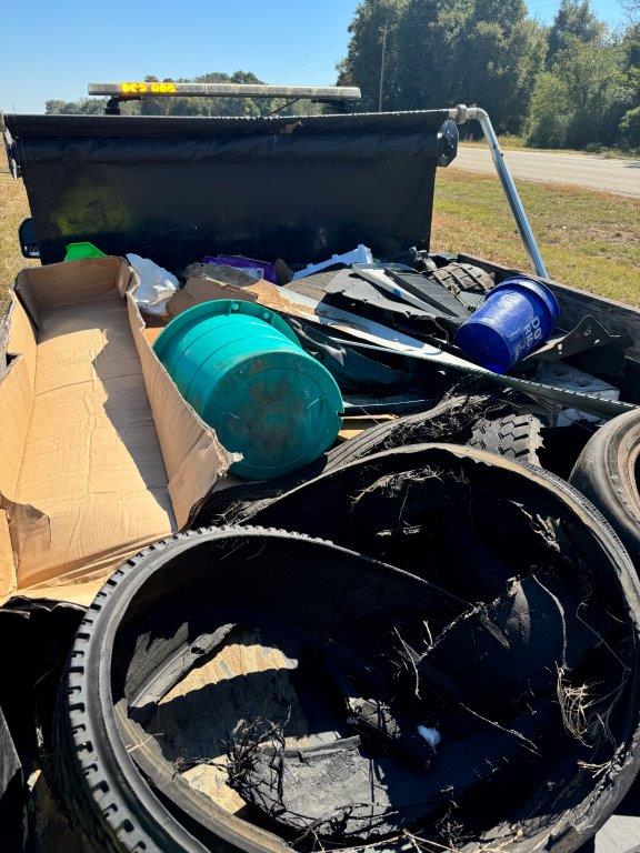 A truck bed full of debris from roadsides in Alabama