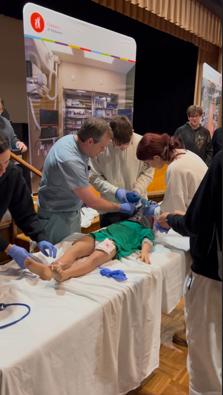 People dressed up as doctors and nurses around a dummy
