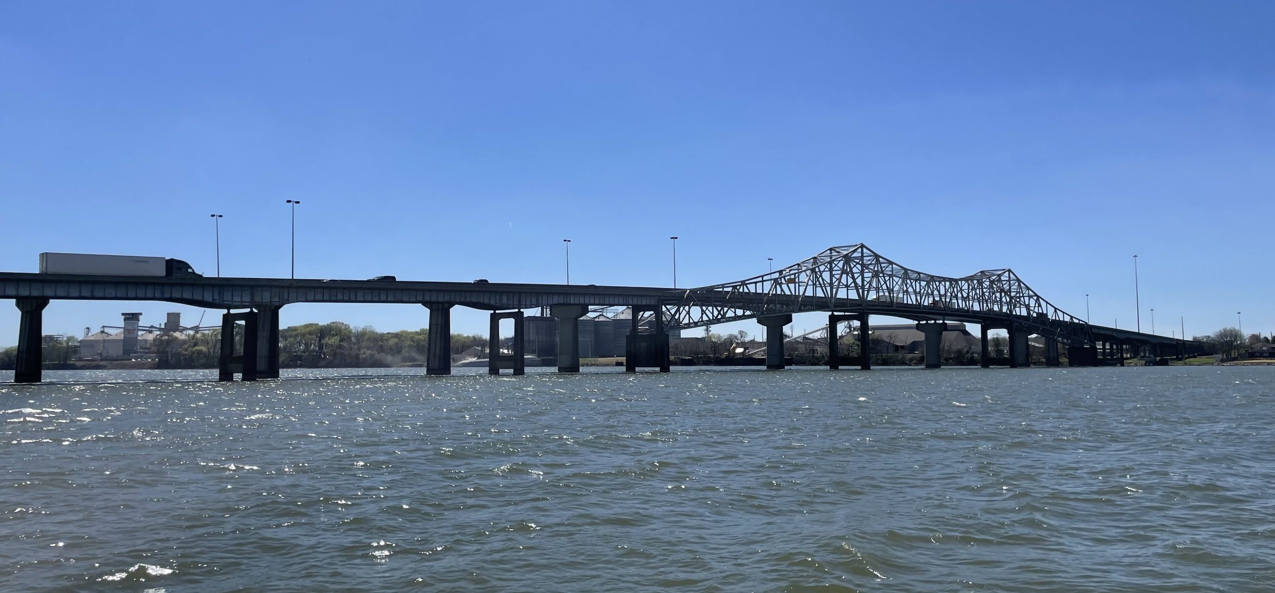 A bridge with a steel truss over a river