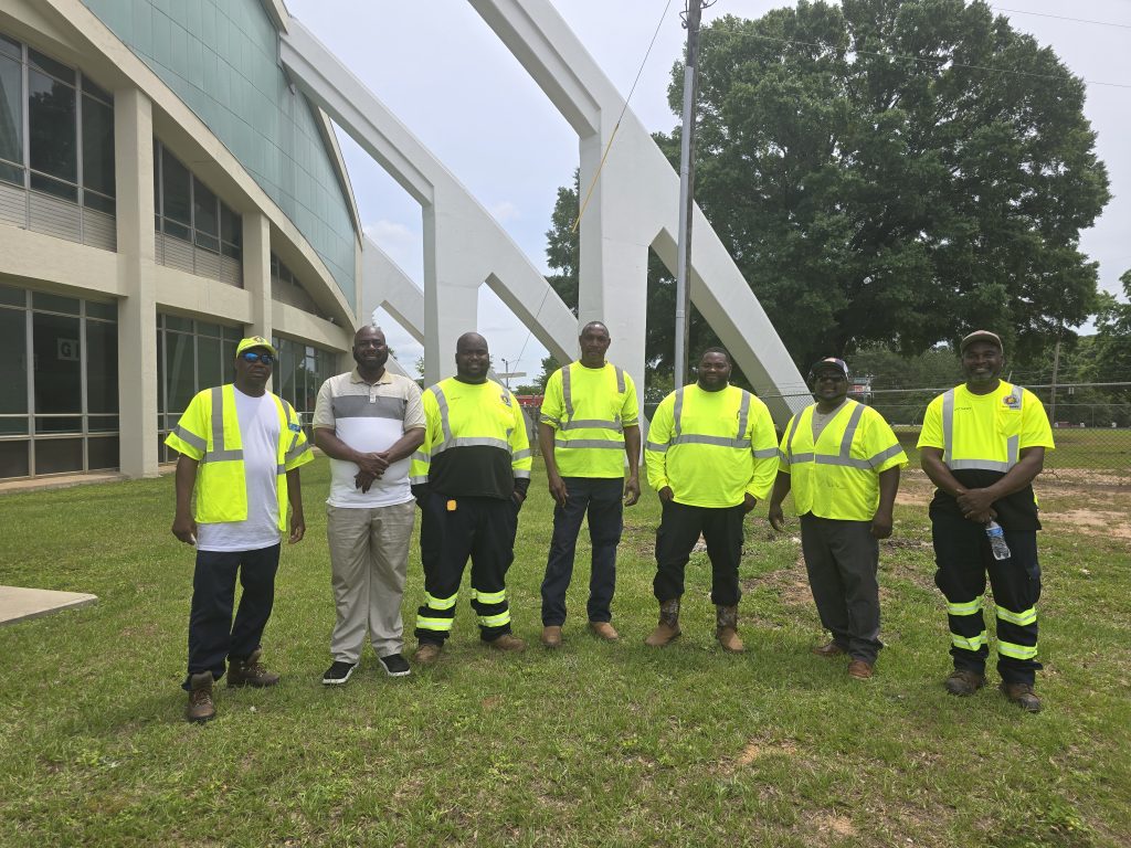 Seven men standing side by side.