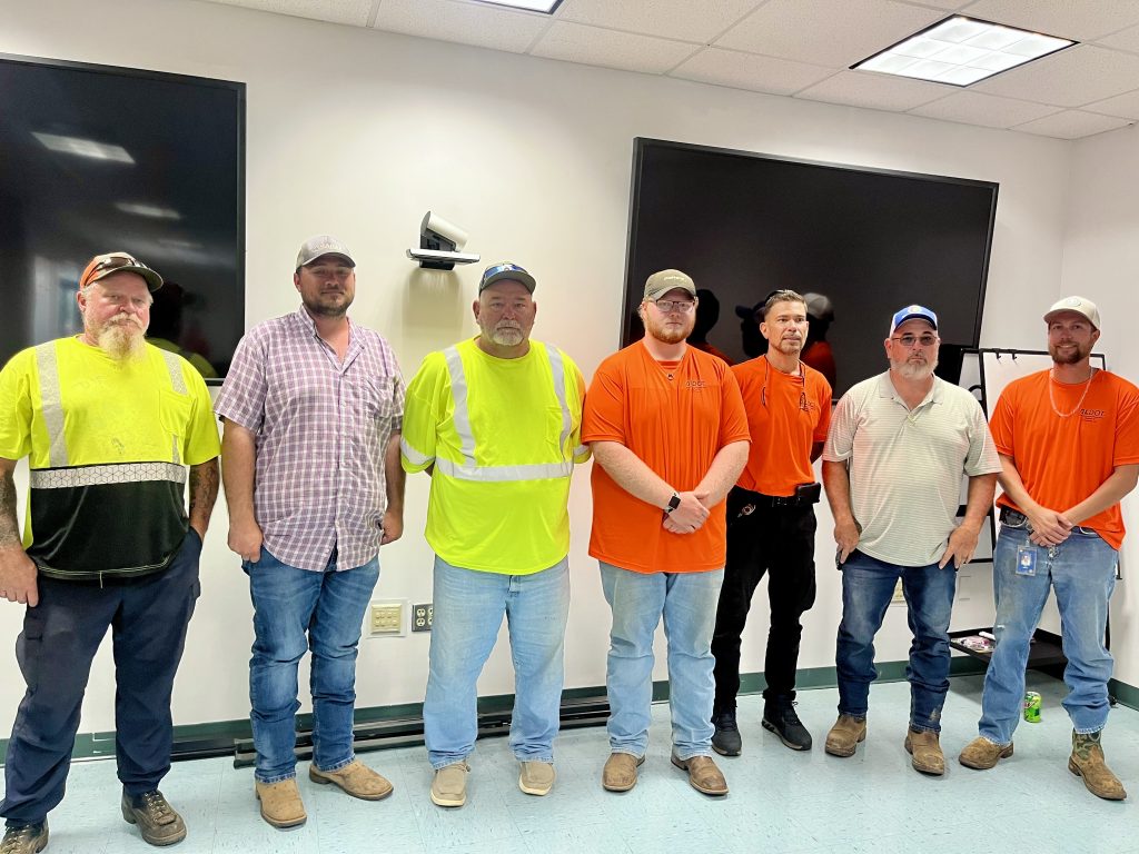 Seven men standing side by side.