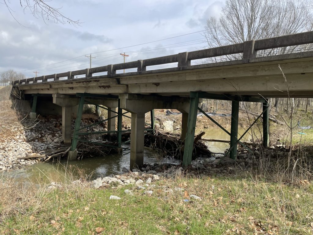 A weathered bridge over a creek