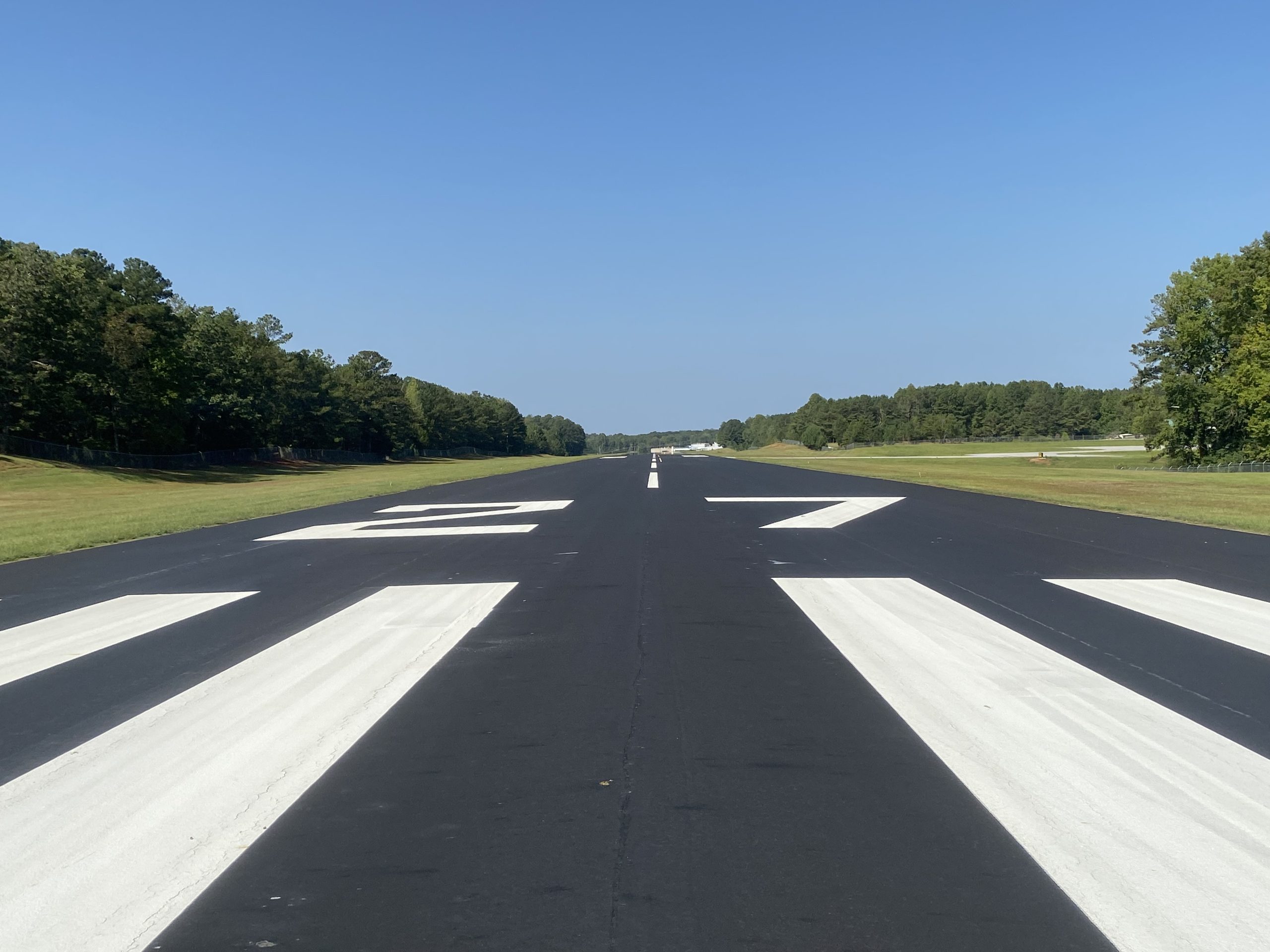 Photo of a repaved and striped airport runway in Alabama funding with the use of state grants.