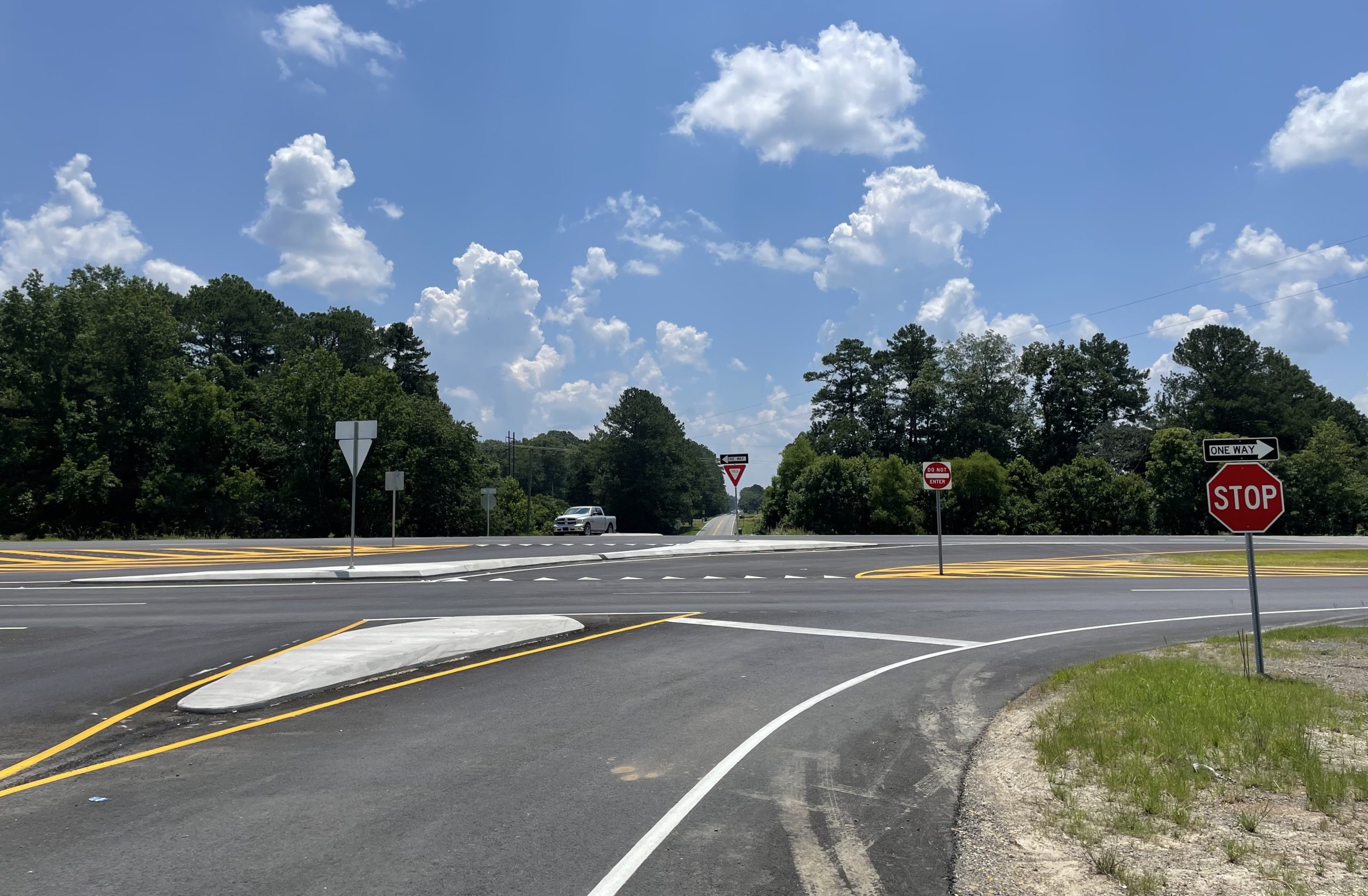 An intersection with channelizing curbs, striping, and signs to direct motorists.
