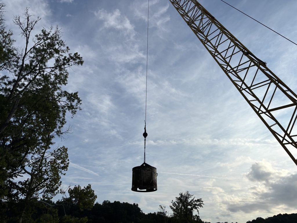 The bucket is a silhouette against the sky