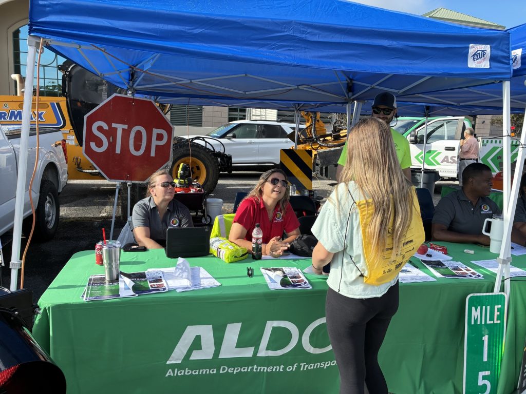 ALDOT workers speak with a freshman student at the ninth annual West Alabama Worlds of Work (WOW) career expo.