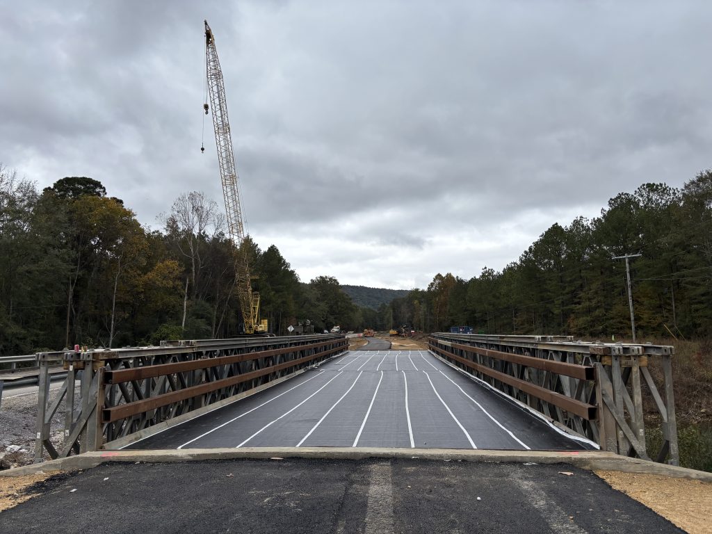 A modular bridge with a crane in the background.