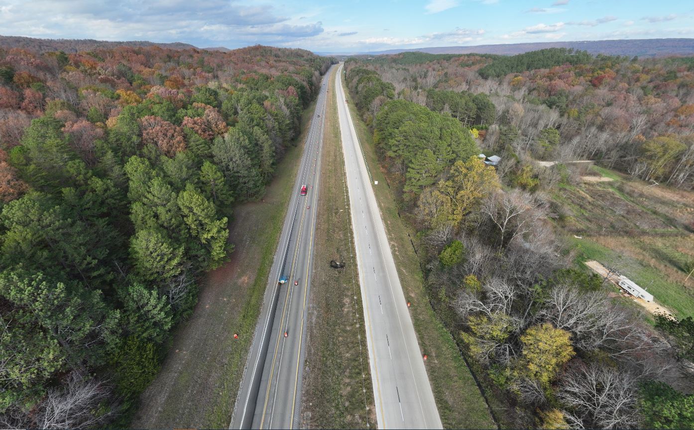 An aerial view of the recent northbound I-59 reconstruction. A median divides the two two-lane roadways. One roadway has been reconstructed in new concrete.