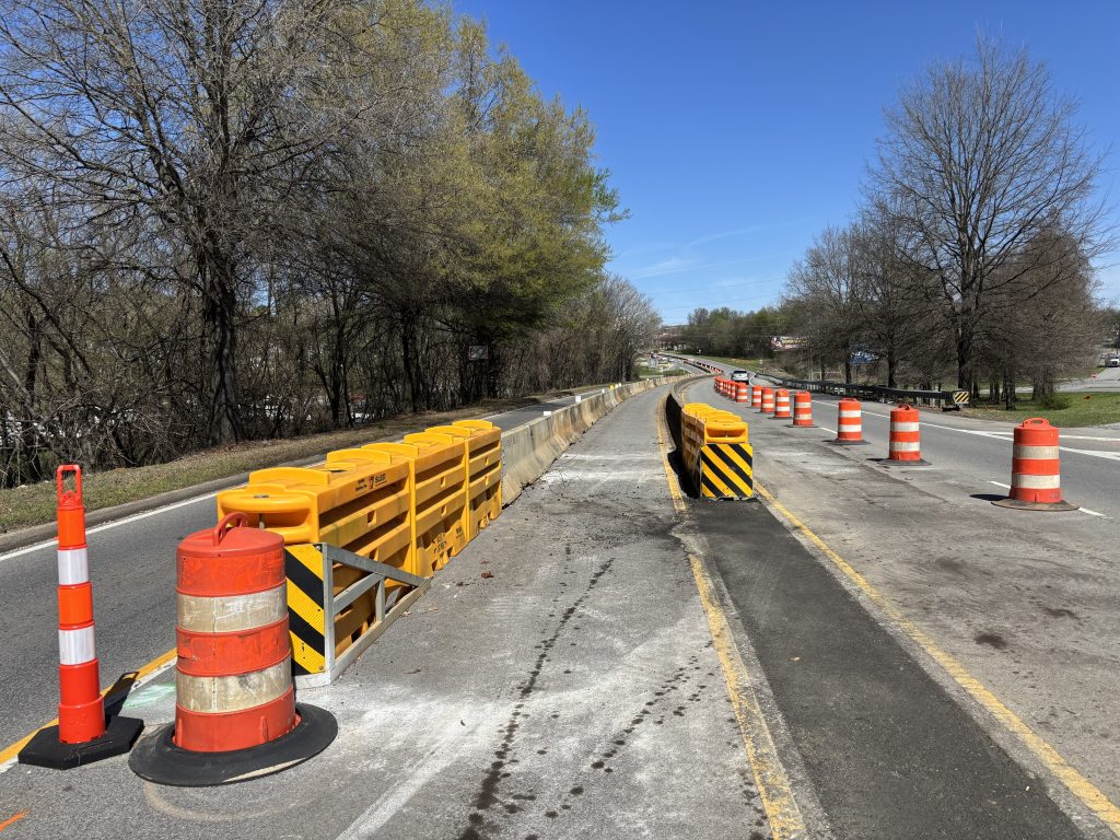 Concrete barriers with attenuators, drums and cones close parts of the highway, reducing it to one lane in each direction at the Mitchell Boulevard bridge.