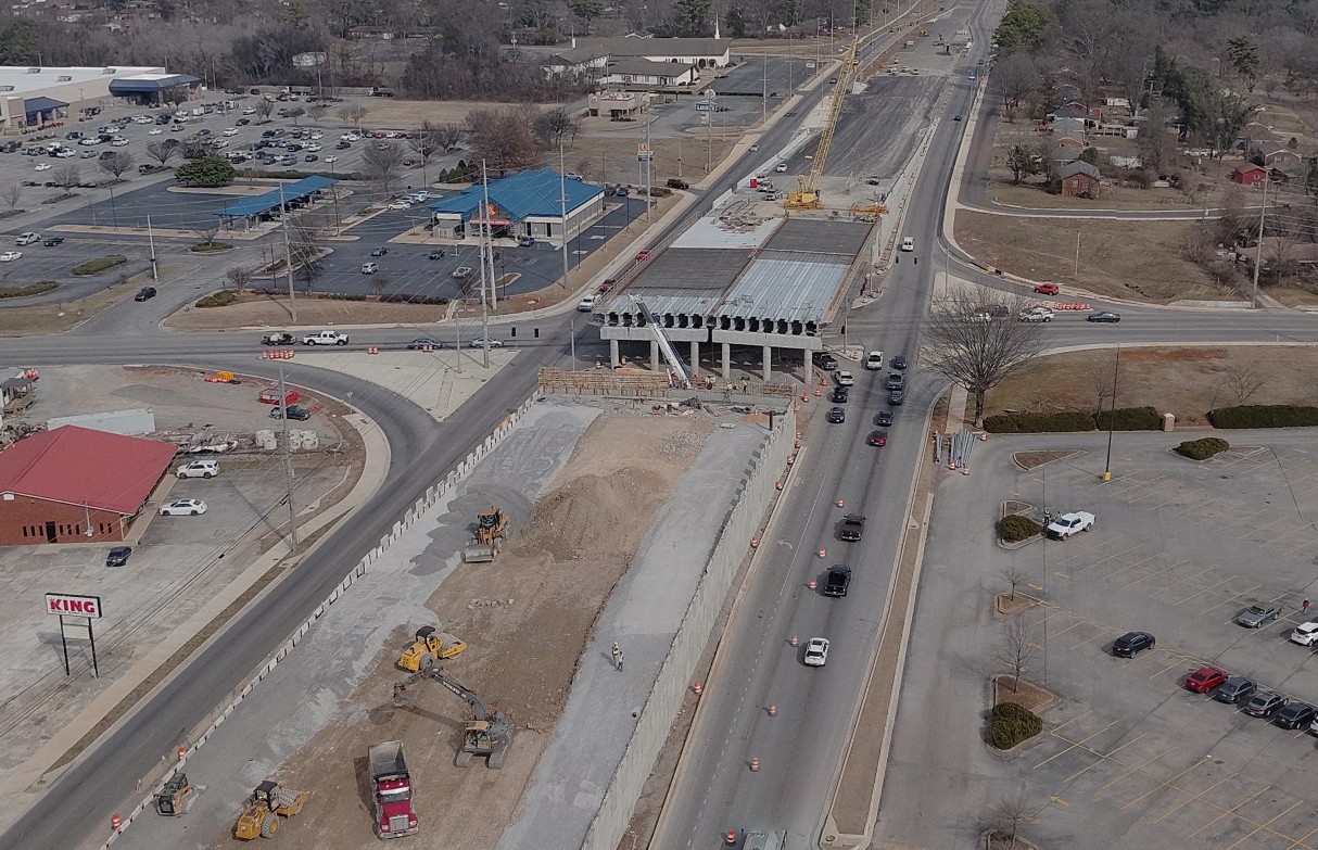 An aerial view of the overpass construction on North Memorial Parkway at Mastin Lake Road in Huntsville. There is a visible gap in the overpass where girders will be installed to form the south span of the bridge.