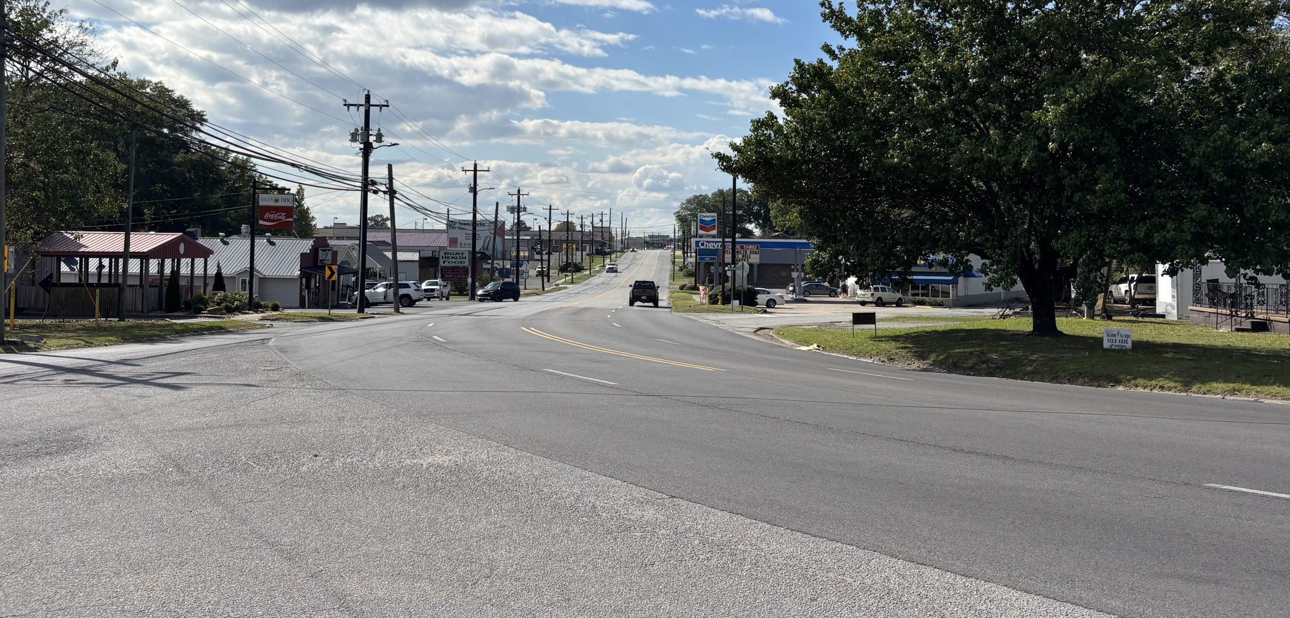 An undivided four-lane highway at a six-way intersection.