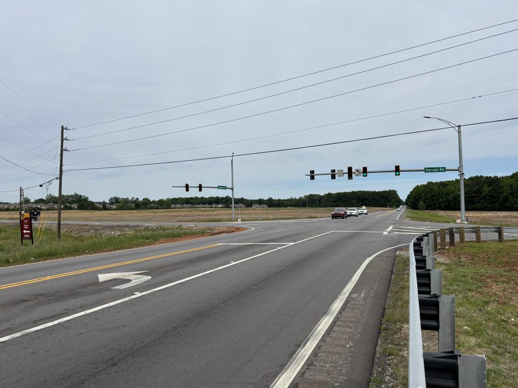 A two-lane highway with a center left turn lane at a signalized intersection.