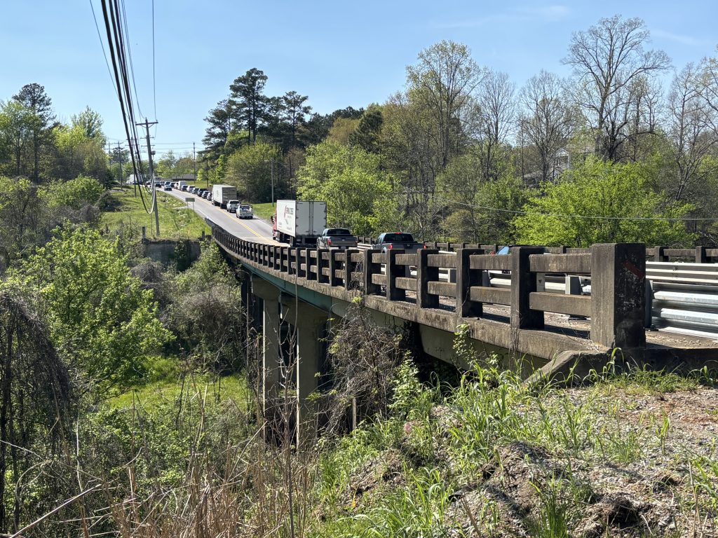 A two-lane bridge with a lot of traffic on it.