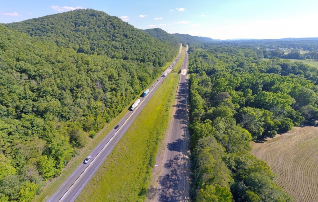 An aerial view of an interstate with one roadway under construction.