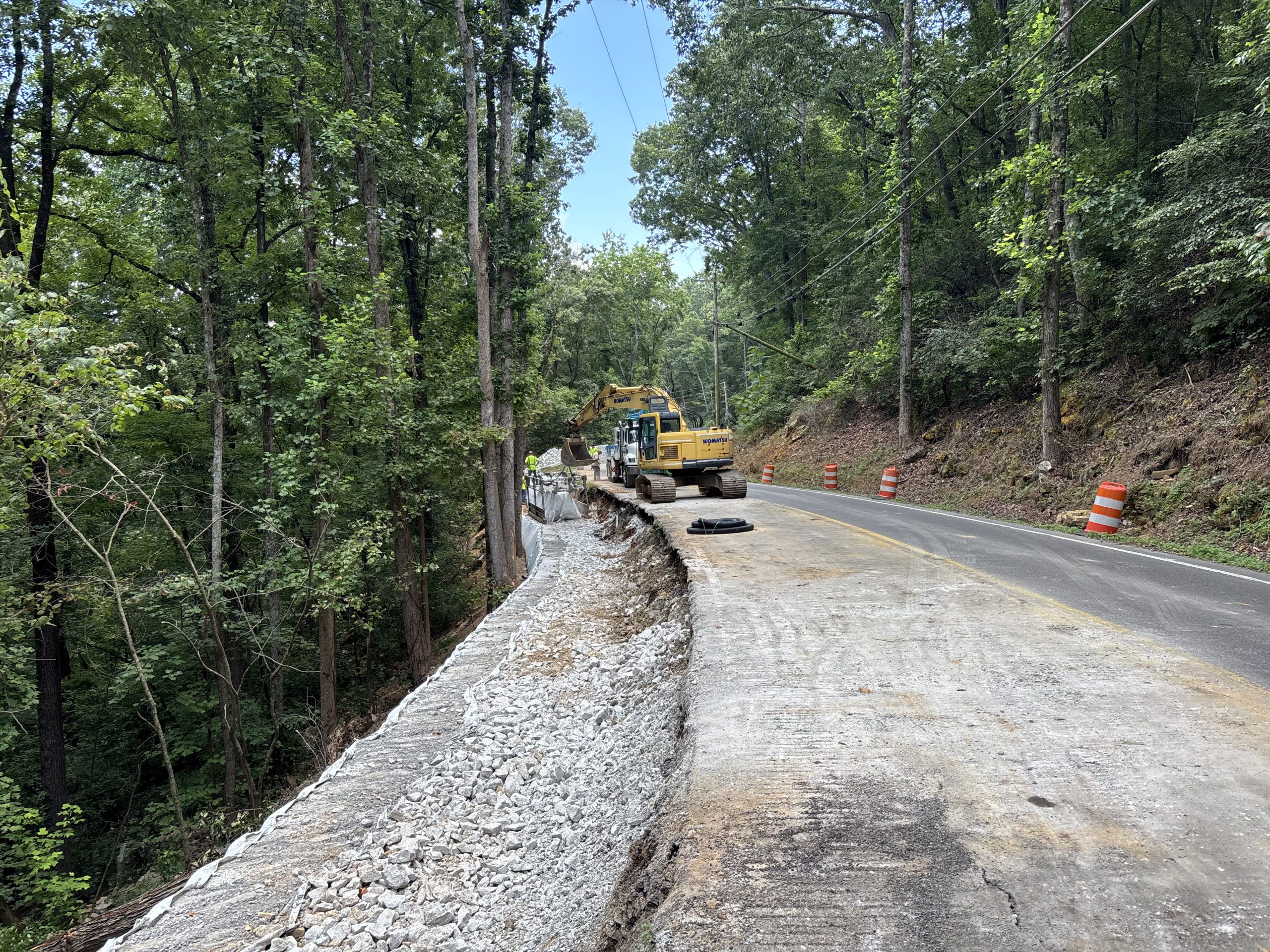 An excavated slope beside SR-227, where a contractor is working to widen sections of shoulder by installing retaining walls.