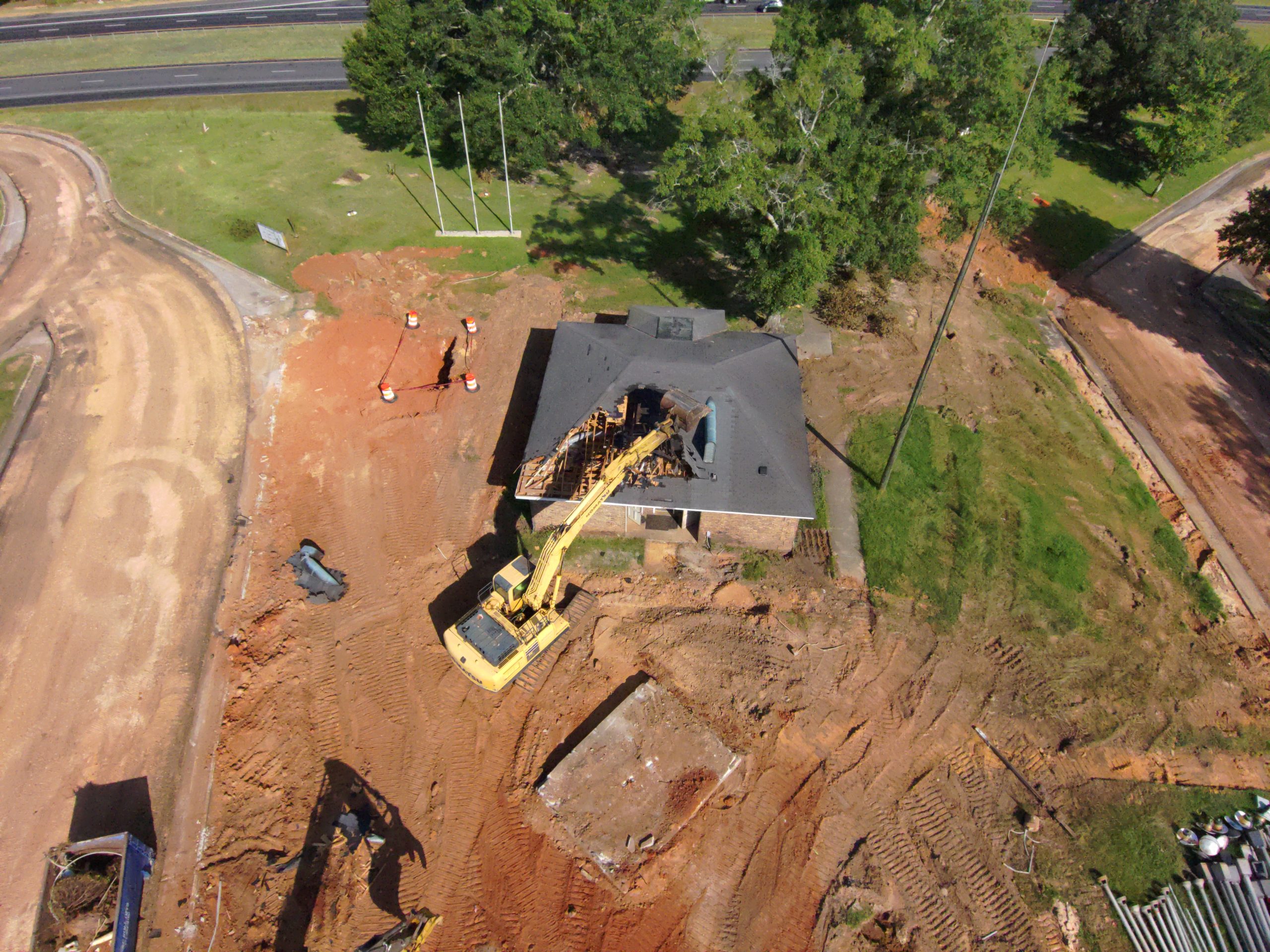 Aerial view of heavy machinery demolishing the building at the I-65 North rest area in Greenville.
