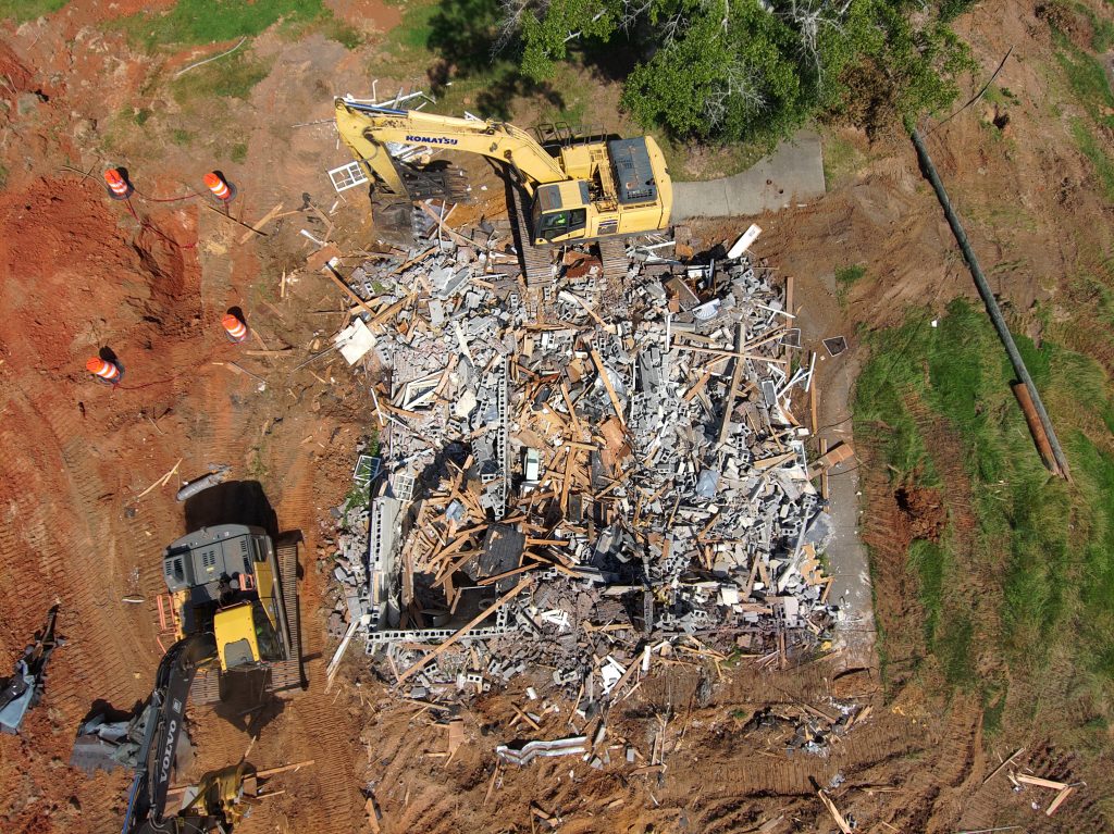 Aerial view of heavy machinery demolishing the building at the I-65 North rest area in Greenville.