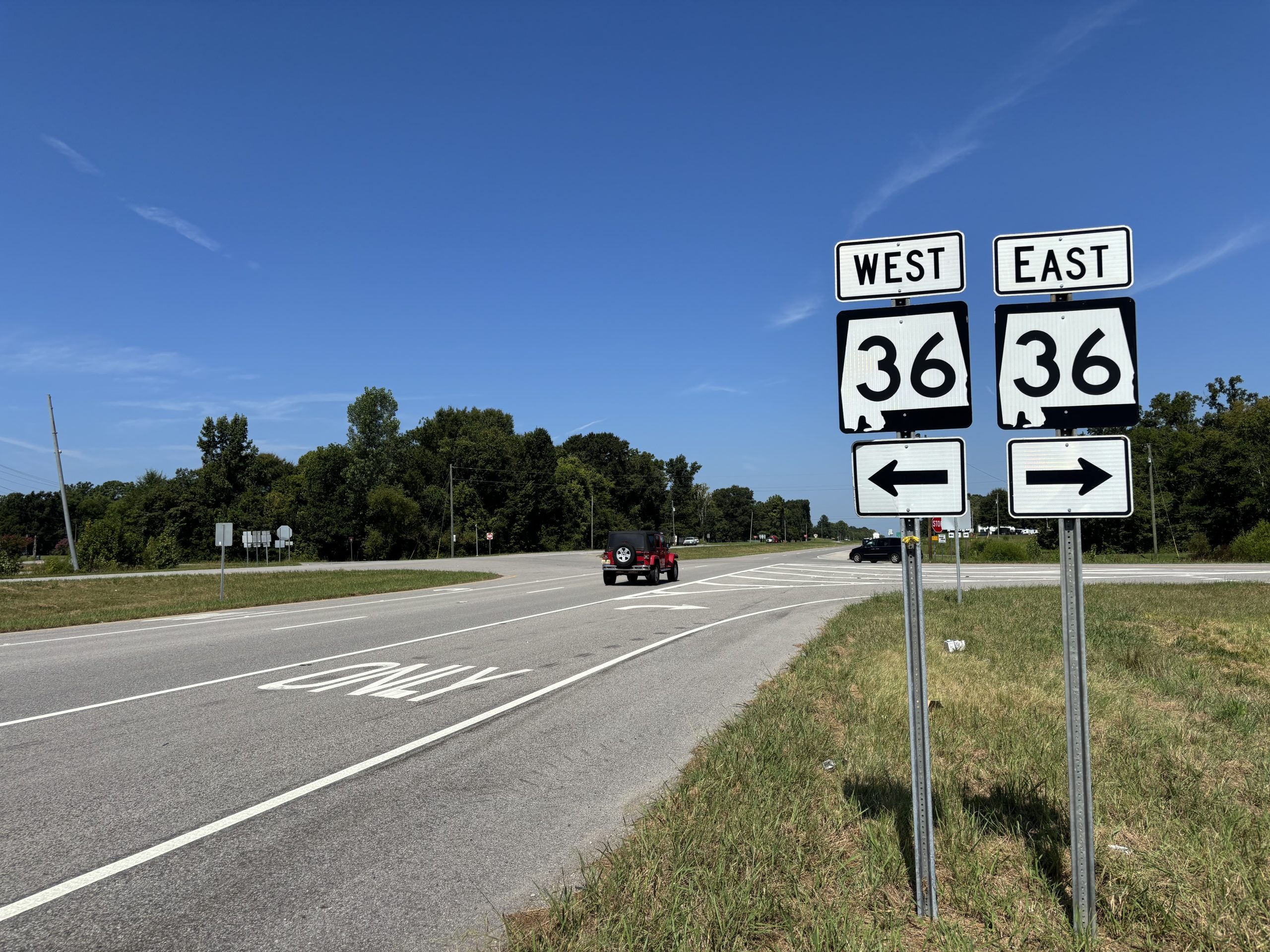 A sign for SR-36, indicating the intersection ahead next to the northbound SR-157 roadway.