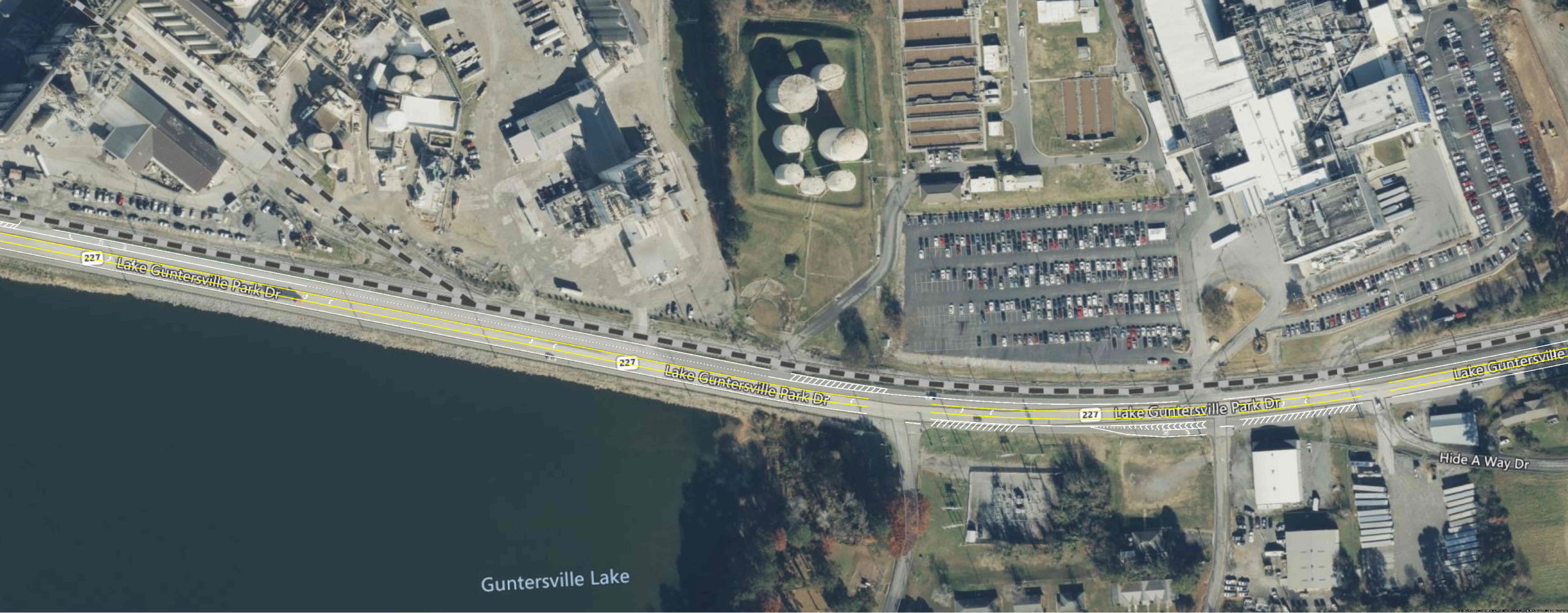 A section of a map showing a three-lane highway along an industrial waterfront area.