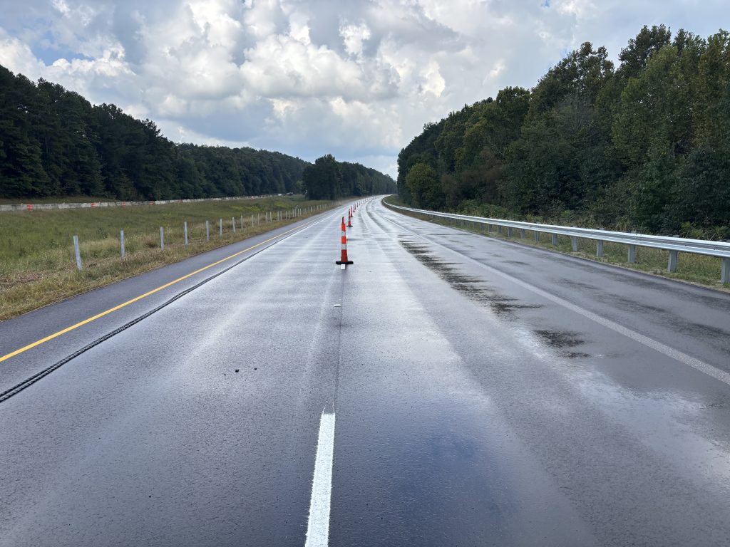 Cones line the center of a new roadway.