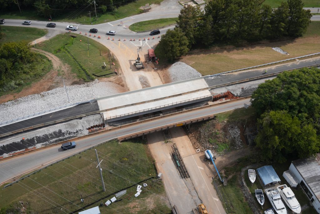 An aerial view of two bridge halves, one of which is new and much larger.