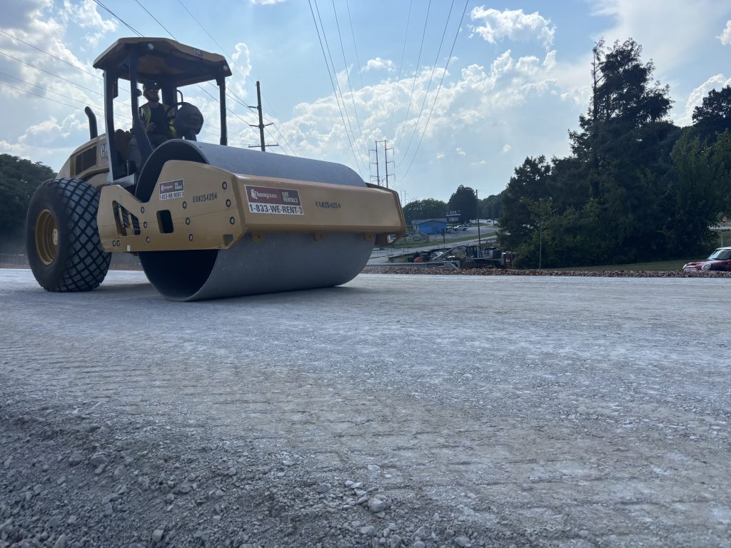A roller compacts aggregate base